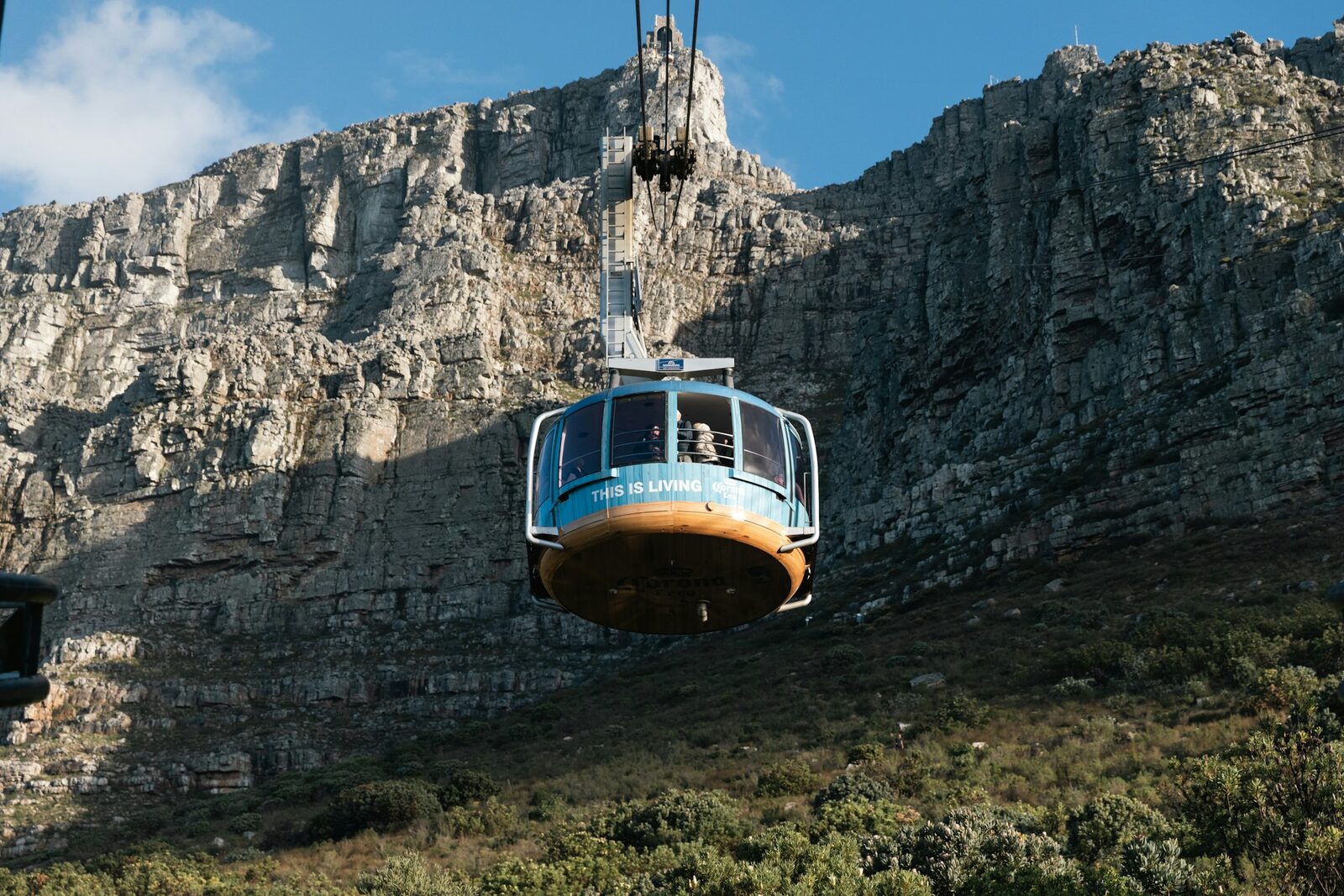 A cable car rising up the sheer cliff face of Table Mountain above Cape Town.