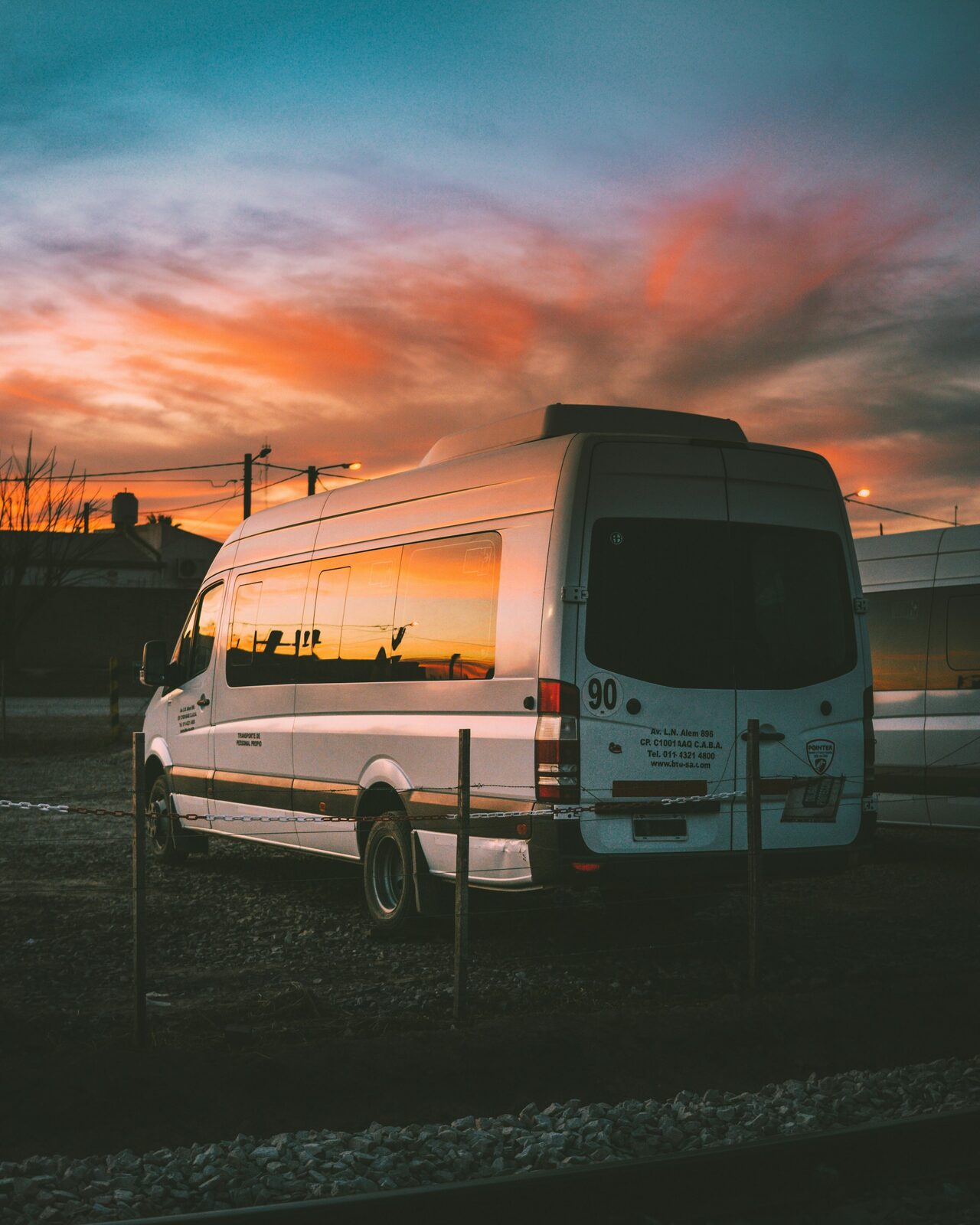 A comfortable passenger van parked at the roadside under an evening sky.