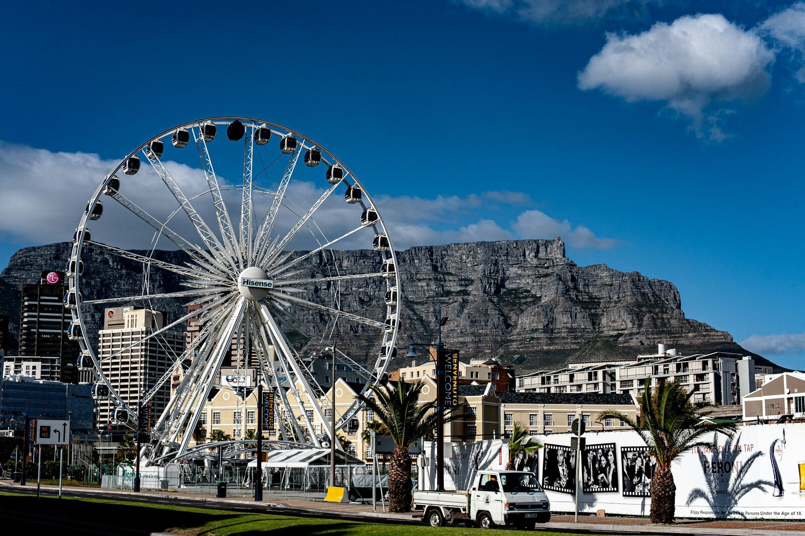 The Cape Wheel at the V&A Waterfront with Table Mountain rising behind the buildings.
